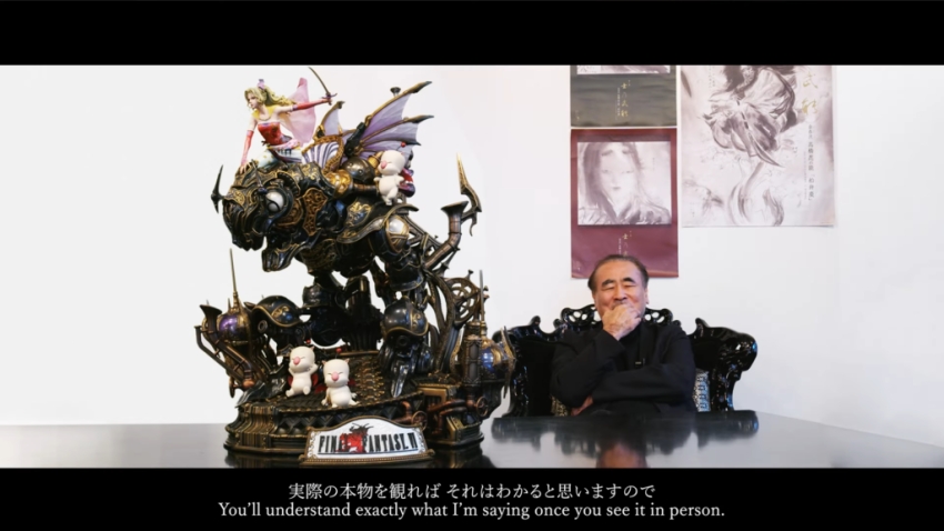 Ein Screenshot aus dem Terra-Statue-Enthüllungsvideo mit dem Künstler Yoshitaka Amano, mit Untertiteln wie folgt: "Sie werden genau verstehen, was ich sage, wenn Sie es persönlich sehen."